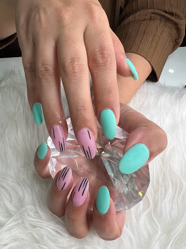 Mint-green and lavender nails with black line art