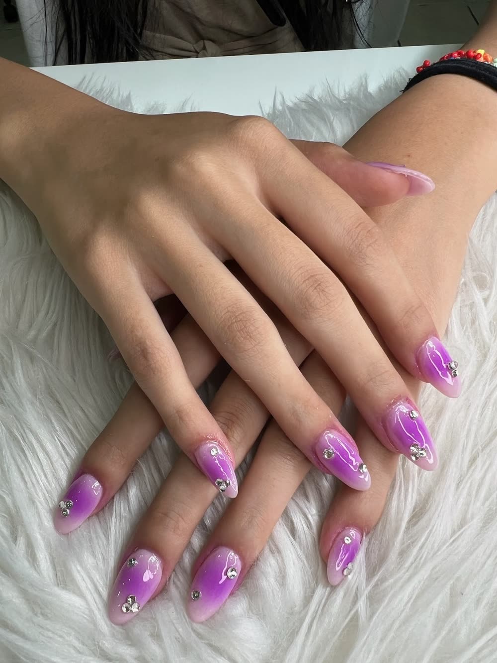 Purple and magenta ombre nails with rhinestones