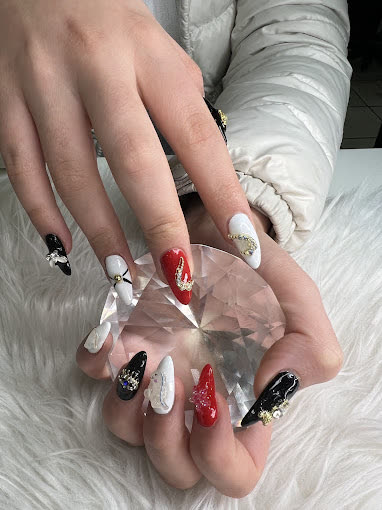 Red, black and white stiletto nails with gold and a glitter heart