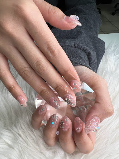 Nude and pink glitter almond nails with silver star charms