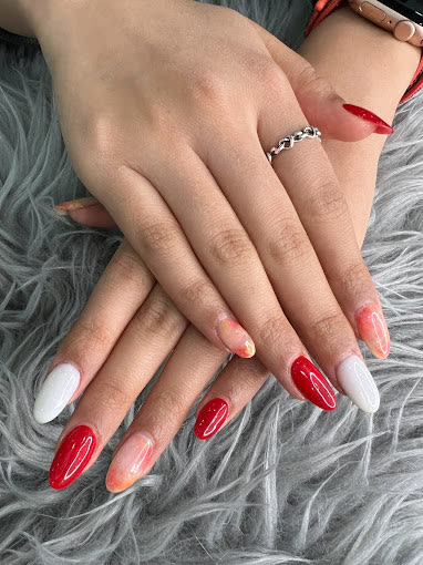 Red, white and nude almond nails with orange accents