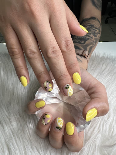 Bright yellow almond nails with lemon-slice art